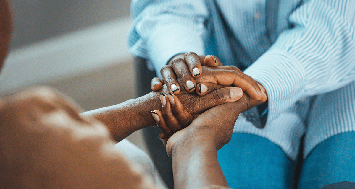 Two people holding hands