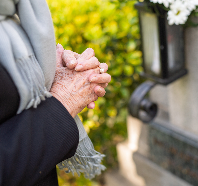 woman praying at grave
