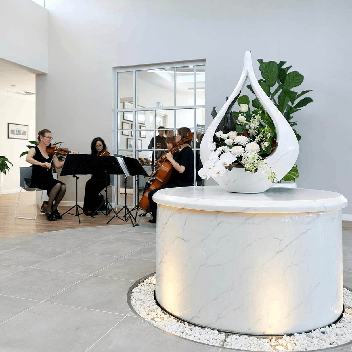 foyer of funeral home with sting band in background