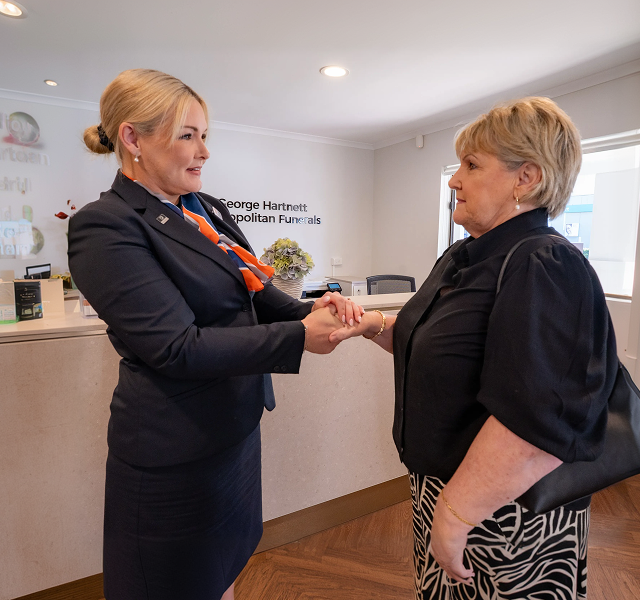 funeral director supporting woman
