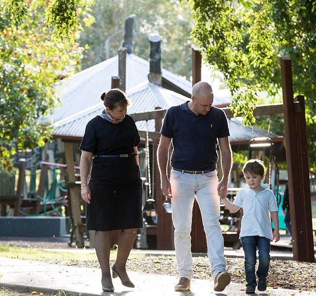 funeral director and family walking in park