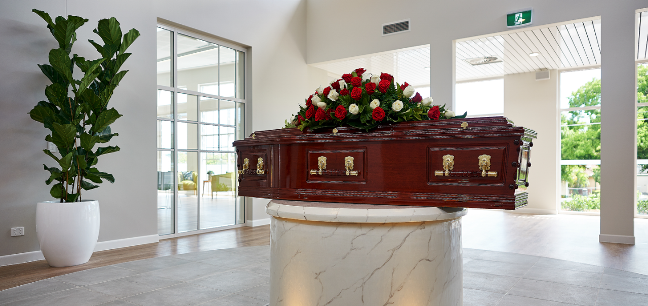 coffin with flower arrangement