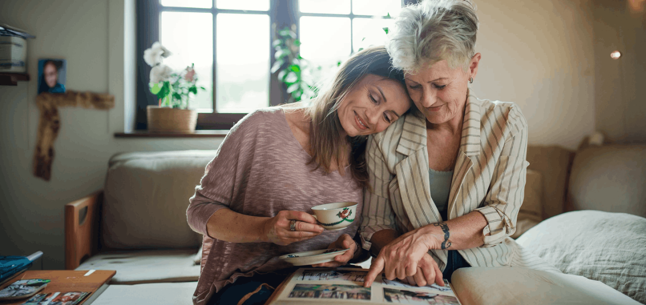 mother and daughter looking at photo album